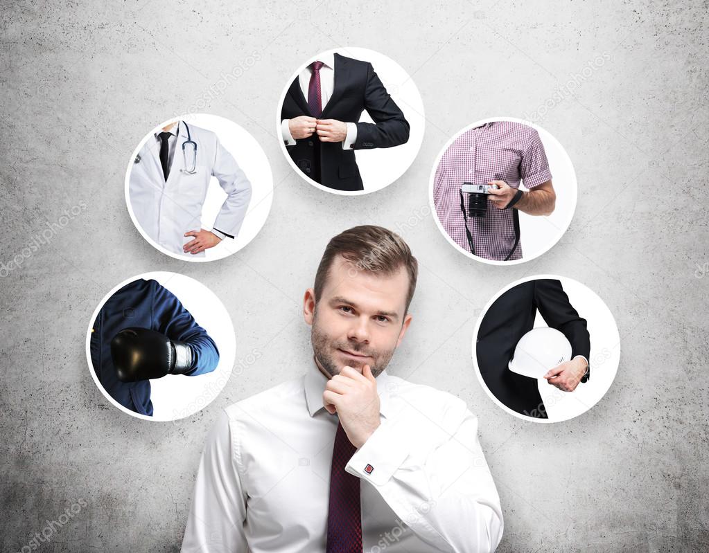 A handsome person in a formal shirt is thinking about different professions. Concrete background.