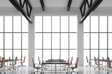 Modern workplaces in a modern bright clean interior of a loft style office. Huge windows with copy space and white walls. Black desks equipped with laptops, brown leather chairs. 3D rendering.