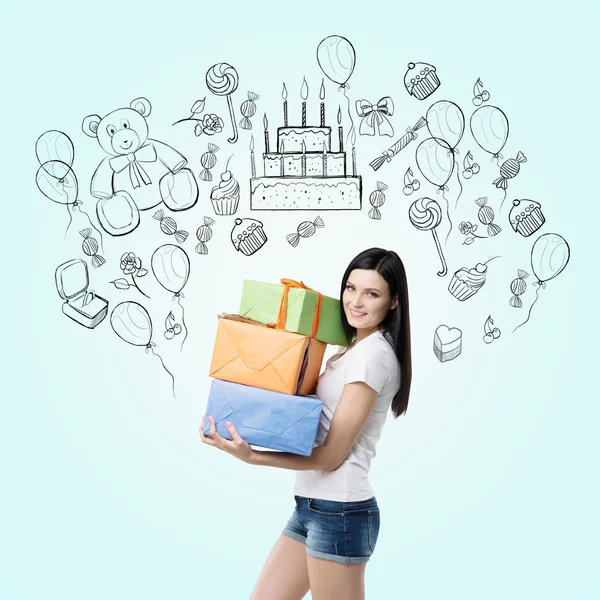 A brunette holds three gift boxes. Birthday celebration sketch is drawn on the light blue background. — Stock Photo, Image