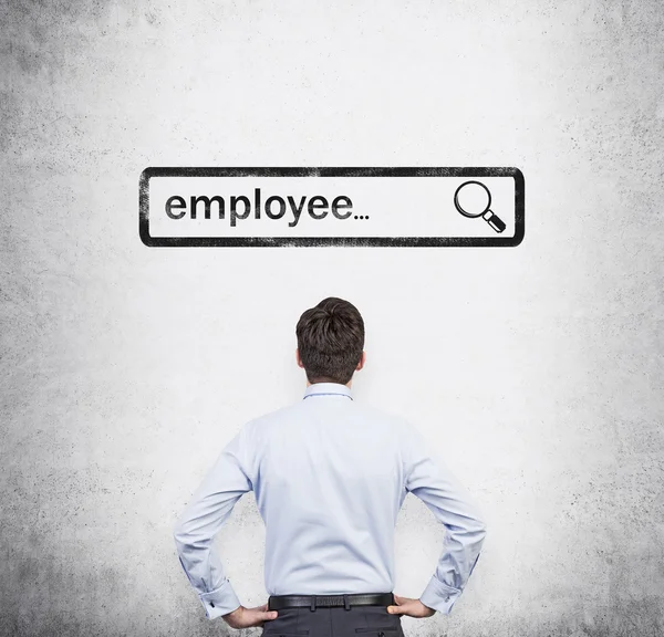 A rear view of the person, who is looking at the drawn search bar with the word ' employee '. The Internet concept of searching available candidates. Concrete wall on the background. — Stockfoto