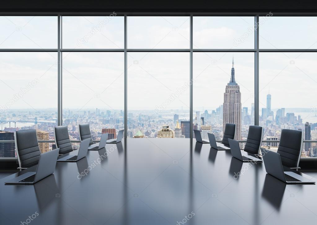 A conference room equipped by modern laptops in a modern panoramic office in New York. Black leather chairs. 3D rendering.