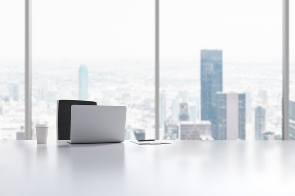 A workplace in a modern panoramic office in Manhattan, New York City. A laptop, notepad and a coffee cup are on the white table. 3D rendering.