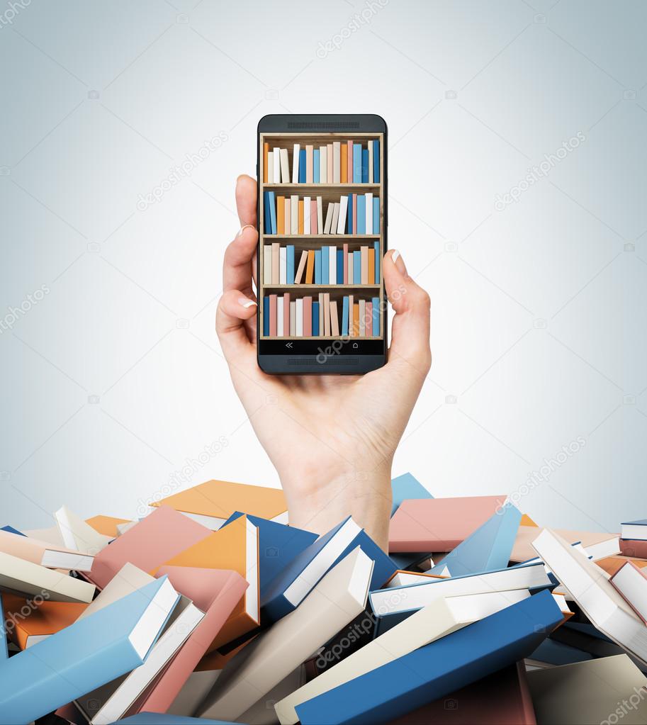 A hand holds a smartphone with a book shelf on the screen. A heap of colourful books. A concept of education and technology. Light blue background.