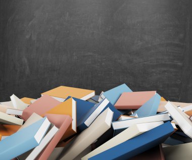 A heap of different books with colorful covers which are laying on the floor. Black chalk board on the background.