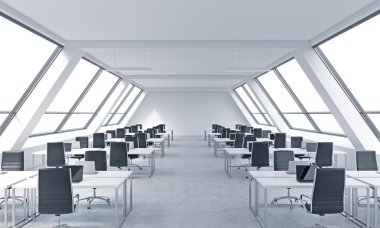 Workplaces in a bright modern open space loft office. White tables equipped by modern laptops and black chairs. White copy space in the panoramic windows. 3D rendering.