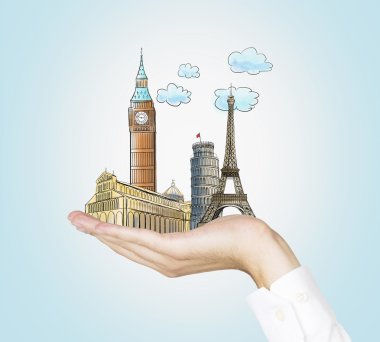 A man's hand holds sketches of the most famous places in Italy, Great Britain and France. The concept of tourism and sightseeing. Light blue background.