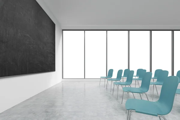 A classroom or presentation room in a modern university or fancy office. Blue chairs, panoramic windows with white copy space and a black chalkboard on the wall. 3D rendering. — Stockfoto