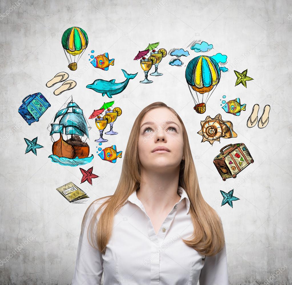 A beautiful woman is looking up by dreaming about vacation. Colourful vacation icons are drawn on the concrete wall around her head.