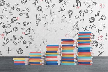 A stair is made of colourful books. Educational icons are drawn on the concrete wall. Wooden floor.