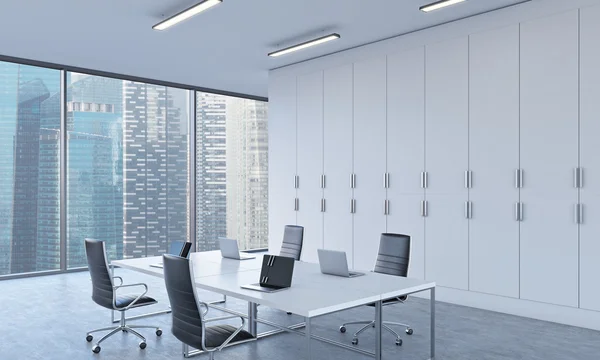 Workplaces or conference area in a bright modern open space office. White tables equipped by modern laptops. Singapore view. 3D rendering. — Stok fotoğraf
