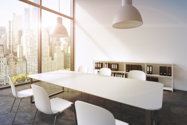 A conference room in a modern panoramic office with New York view. White table, white chairs, a bookcase and two white ceiling lights. 3D rendering. A sunset. Toned image.