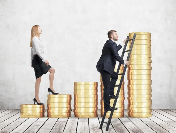 A woman in formal clothes is going up using a stairs which are made of golden coins, while a man has found a shortcut how to reach the final point. A concept of success. Concrete background. — Stock Photo, Image
