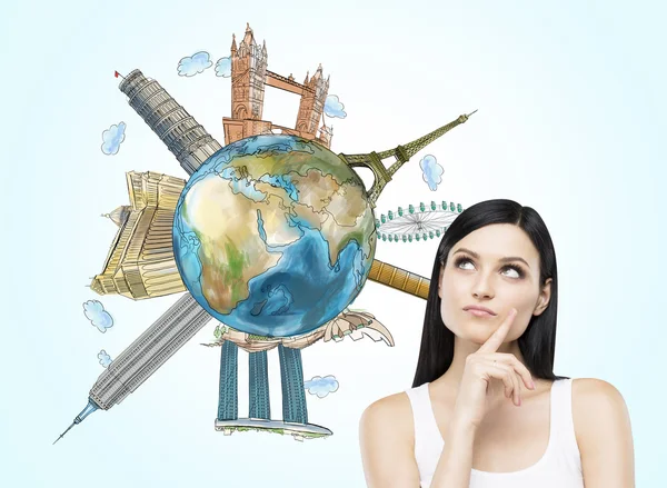 A brunette woman thinks about travelling. A globe with sketched famous places. Light blue background. Elements of this image furnished by NASA. — Stock Fotó