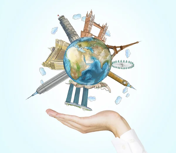 A hand holds a globe with sketched the most famous places in the world. A concept of tourism and sightseeing. Light blue background. Elements of this image furnished by NASA. — Stock Photo, Image