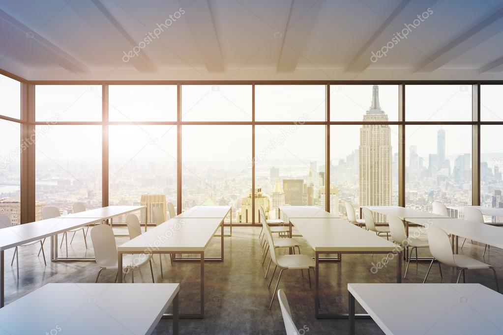 A modern panoramic classroom with New York view. White tables and white chairs. 3D rendering. Sunset. Toned image.