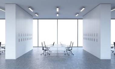 Workplaces in a bright modern open space office. White tables equipped by modern laptops and black chairs. White copy space in the panoramic windows. 3D rendering.