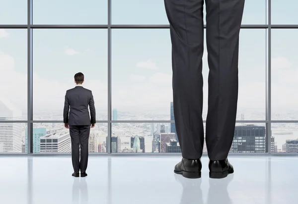 Vista trasera de dos profesionales en suites formales que se paran frente a una ventana panorámica con vista a la ciudad de Nueva York. Concepto de servicios de consultoría profesional . — Foto de Stock