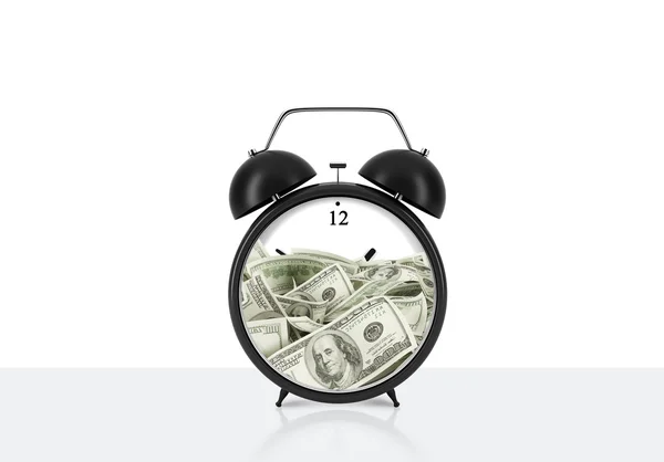 An alarm clock with dollar bills inside is on the table. The concept of 'time is money' and a time management. White background. — Zdjęcie stockowe
