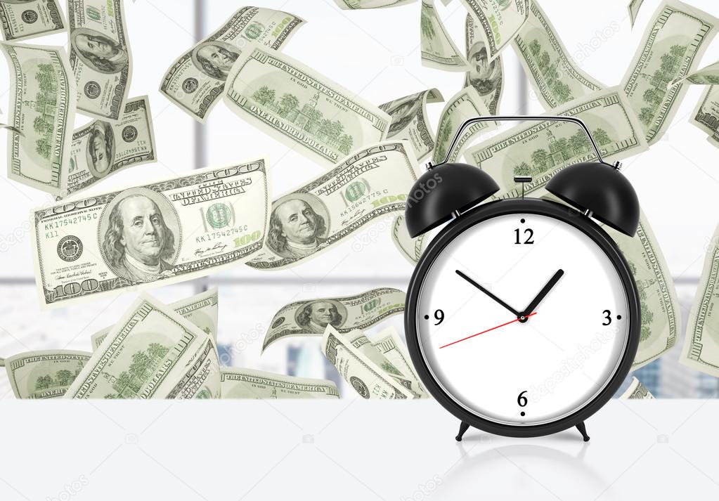 An alarm clock is on the table. Falling dollar notes on background. The concept of 'time is money' and a time management.