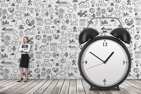 A huge alarm clock on the front view and there is a business lady with black document file. Business icons are drawn on the concrete. — Stock fotografie
