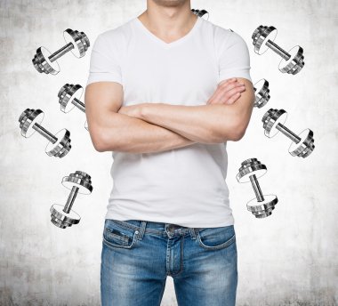 A man with crossed hands is pondering about weights. Weight icons are drawn over the concrete background.