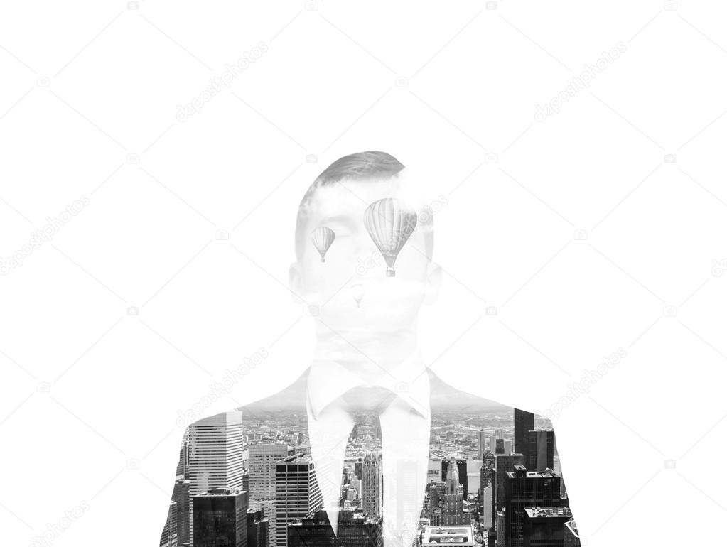 Black and white image. A transparent silhouette of a businessman. New York city view inside the silhouette. White background.