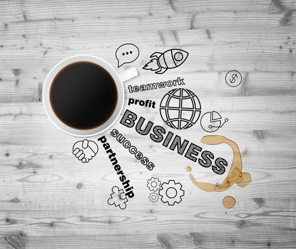 Top view of a cup of coffee and black business icons which symbolises a success in Business. Wooden background as a table. — Stock fotografie