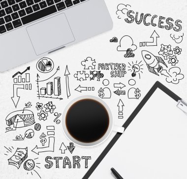 Top view of a coffee cup with notepad and a laptop. Black charts on the white desk. A concept of start up new business.