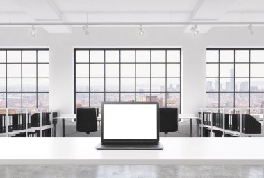A workplace in a bright modern loft open space office. A working desk is equipped with a modern laptop with white copy space in the screen. Docs shelves. New York view in the windows. 3D rendering.