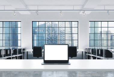 A workplace in a bright modern loft open space office. A working desk is equipped with a modern laptop with white copy space in the screen. Docs shelves. Singapore view in the windows. 3D rendering.