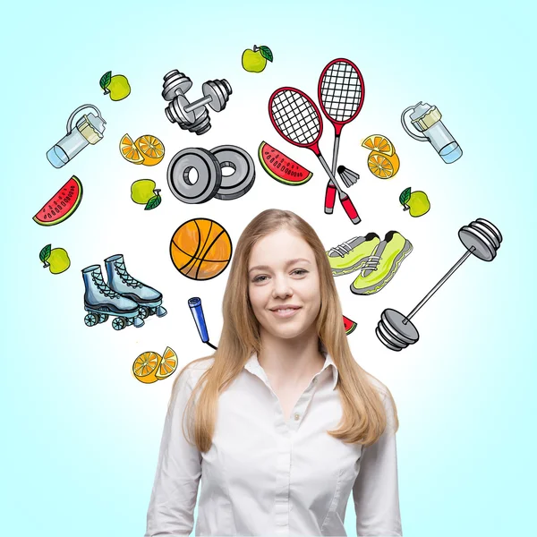 Una hermosa dama que está tratando de hacer una elección a favor de una determinada actividad deportiva. Los coloridos iconos deportivos se dibujan sobre el fondo azul claro. Un concepto de un estilo de vida saludable . —  Fotos de Stock