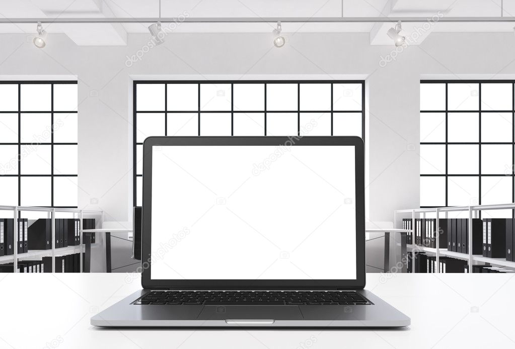 A workplace in a bright modern loft open space office. A working desk is equipped with a modern laptop with white copy space in the screen. Docs shelves. White copy space in the windows. 3D rendering.