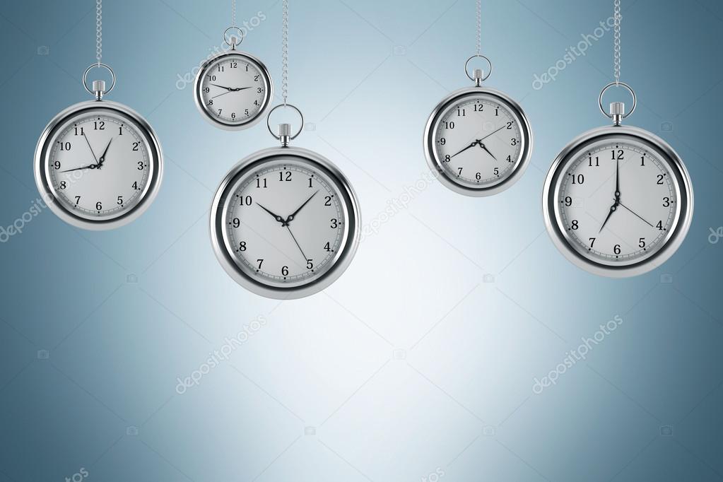 Four models of pocket watches are hovering in the air. A concept of a value of time in business. Light blue background. 3D rendering.
