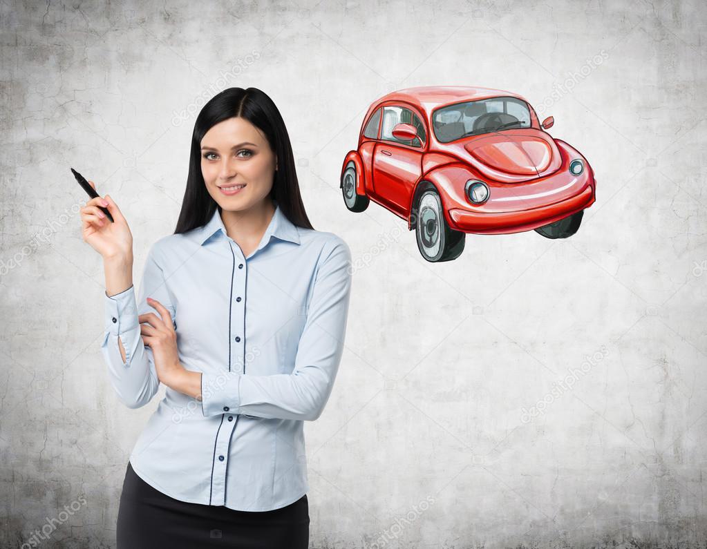 A brunette woman is teaching a basis of road traffic regulations. A sketch of a red car is drawn on the concrete wall.
