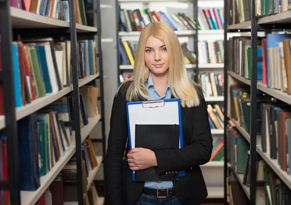 Smiling young lady with loose long blonde hair standing and hold — Stock fotografie