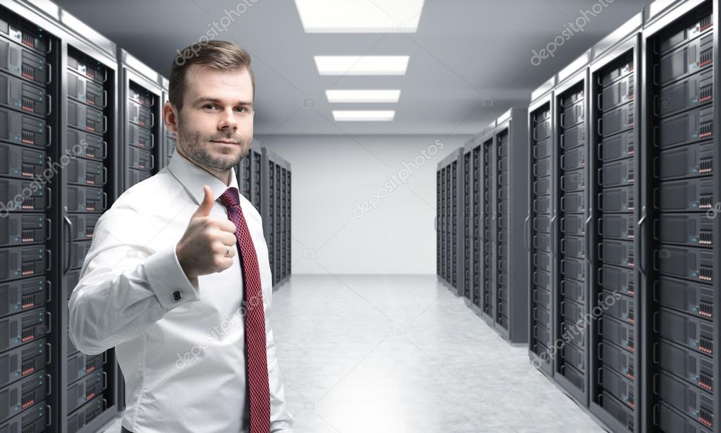 man with his right thumb up in server room for data storage, pro
