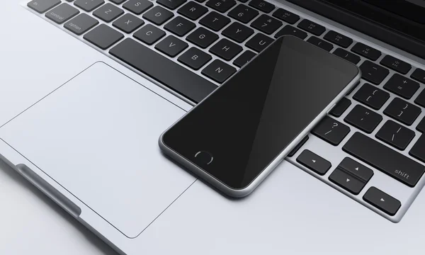 Smartphone no teclado do laptop no escritório, comunicação — Fotografia de Stock