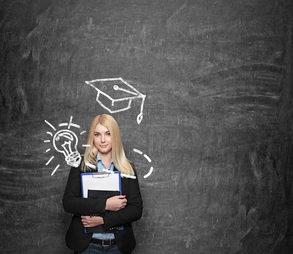 Young girl holding note books, drawn academic hat above her — Stockfoto
