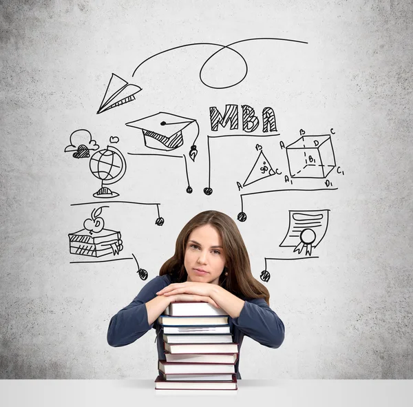 Woman with hands and head on pile of books thinking — Stock Photo, Image