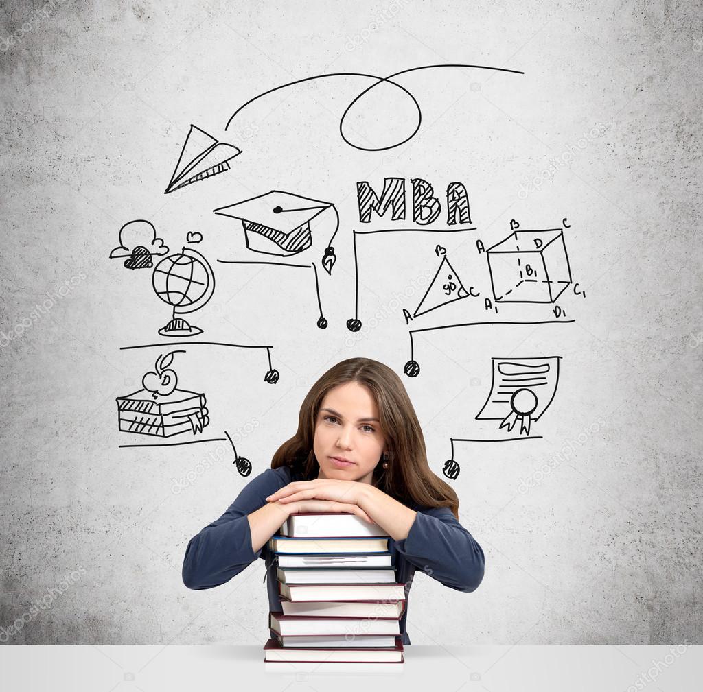 woman with hands and head on pile of books thinking