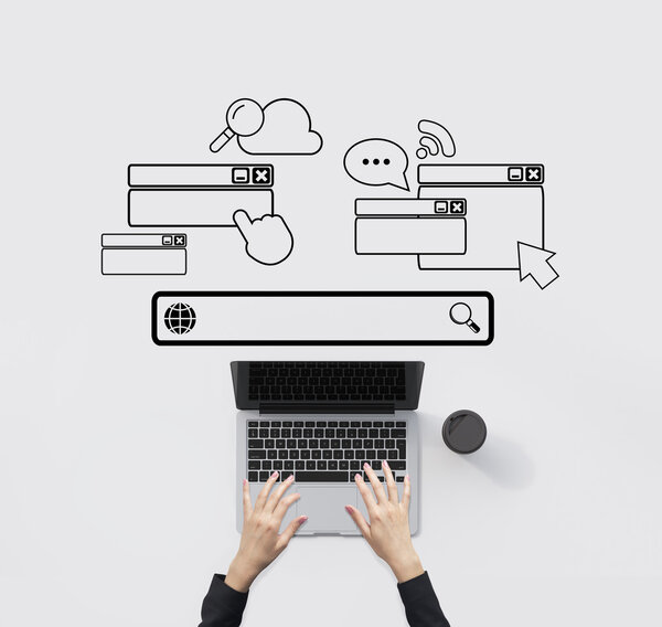 Hands typing on laptop