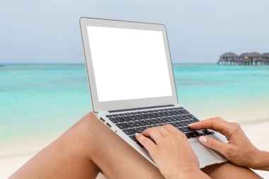 Woman with computer on the beach