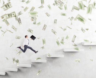 Successful young businessman with a folder in hand running upstairs along a white wall