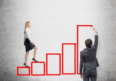 Young businessman painting a contour of a red bar chart.