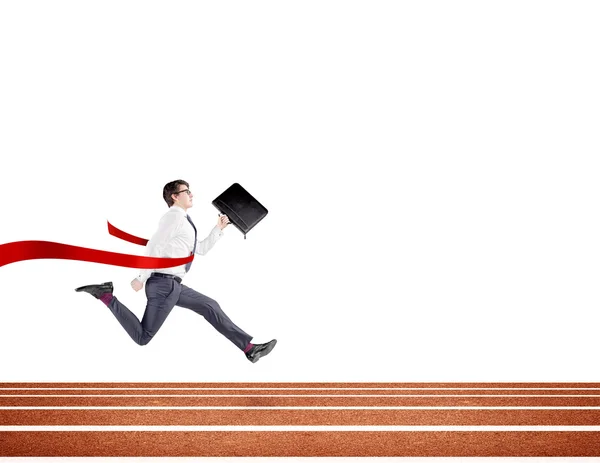 A young businessman running forward on track with a black folder in hand crossing the red finish line. White background. Concept of victory. — Stok fotoğraf