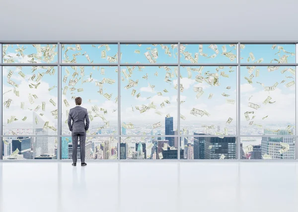 Man in an office in front of the window — Stockfoto