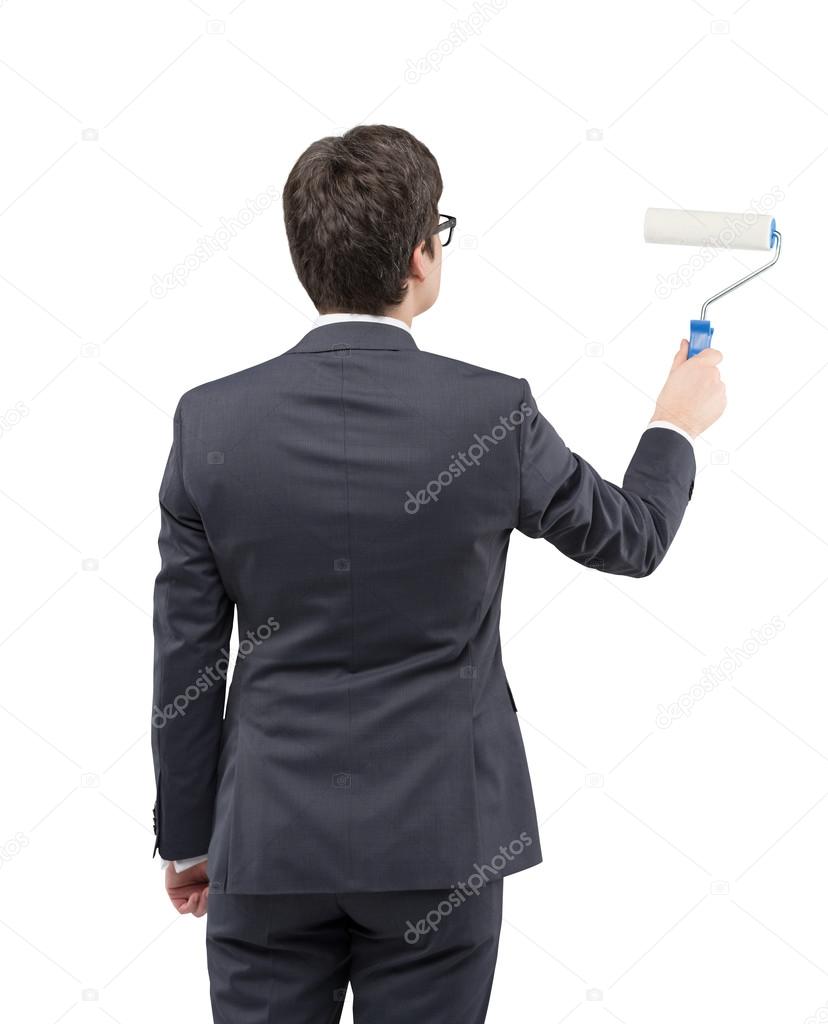 Businessman painting on a white wall