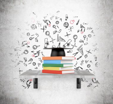 Pile of books and academic hat