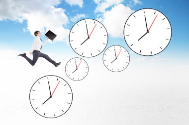 Young businessman with a folder in hand running up six clocks.