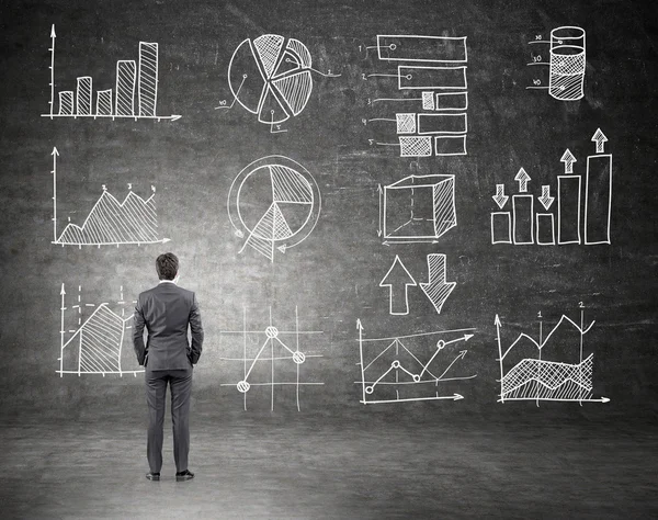 Businessman looking at trade graphs — Stock fotografie